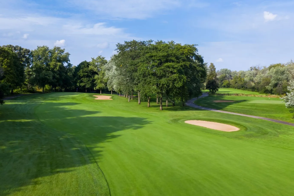 Golf course with trees and bunker